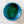 Geometric blue and green patterned object on a textured white background